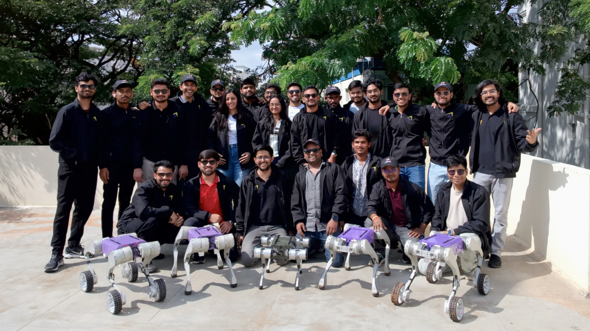 The xTerra Robotics team posing with their robots on a rooftop
